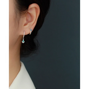 Close-up of s925 silver hoop earrings with blue opal and sparkling pave diamonds