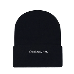 Minimalist black knit beanie featuring white absolutely not embroidery in a street style