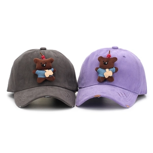Detailed shot of distressed cotton baseball caps featuring cute 3D bear patches