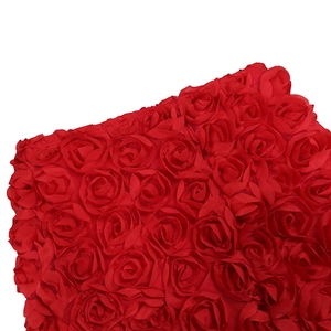 Detailed macro view of 3D red fabric roses featuring dense floral texture and petals
