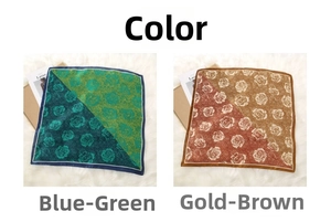 Detailed close-up of rose print silk scarves in blue-green and golden-brown tones