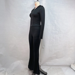 Detail view of black zip-up hoodie and high-waisted flare leggings on a mannequin