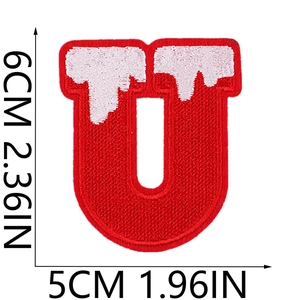 Detailed view of red embroidered letter U patch with snow decoration and dimensions
