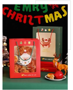 Close-up of festive Christmas gift bags with transparent window and woven rope handles