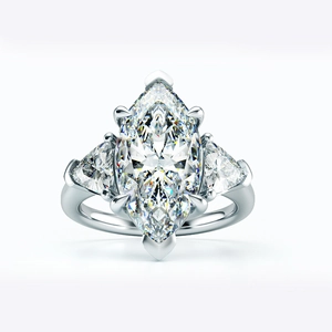 Macro detail of marquise cut high carbon diamond ring in a classic silver three-stone setting