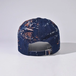 Rear view of denim baseball cap with tie-dye pattern and adjustable metal buckle