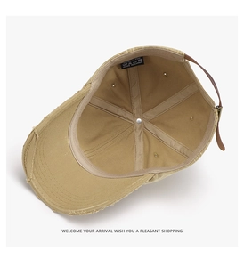 Detail of 100% cotton baseball cap showing distressed brim and leather strap back