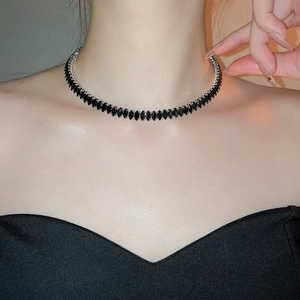 Macro detail of marquise cut black zircon choker on neck with silver metal base