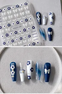 Macro view of 5D embossed nail stickers featuring navy blue frangipani and bows