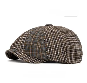 Detailed view of army green checkered newsboy cap featuring vintage distressed fabric texture