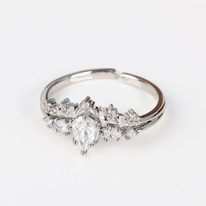 Detail of silver adjustable ring featuring a pear-cut zircon and leaf-shaped metal accents