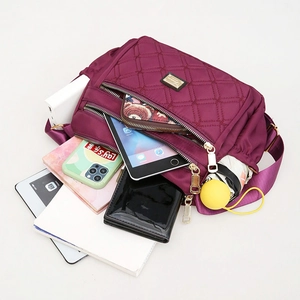 Large capacity purple quilted oxford fabric shoulder bag showing interior storage space