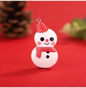 Detail of a resin snowman charm with red striped hat and metal ring for DIY Christmas decor