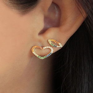 Close-up of heart and lip stud earrings with colorful cubic zirconia in golden finish