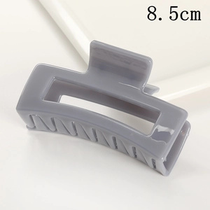 Detail shot of the 8.5cm gray rectangular matte hair claw with geometric hollow design