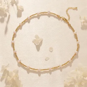 Detailed view of French pearl necklace with golden beads and lobster clasp closure