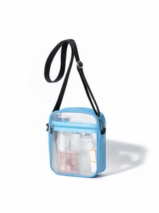 Close-up of blue transparent PVC crossbody bag with adjustable strap and front pocket