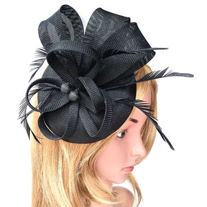 Elegant black feather fascinator hat with mesh veil shown from a side profile view