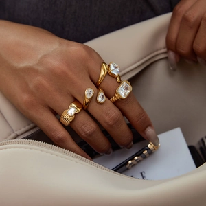 Luxurious gold stainless steel ring set with zircon stones shown on a model's hand