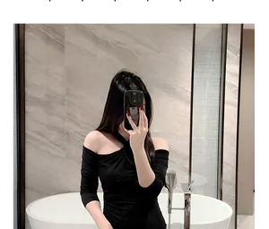 Close-up of black halter neck off-shoulder knit top with crossover neckline detail