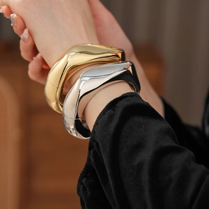 Irregular textured open bangles in gold and silver finish for minimalist fashion style