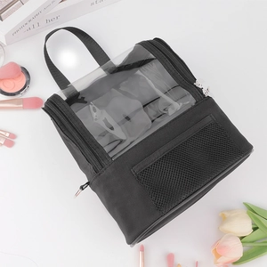 Detailed view of the clear PVC window and reinforced handle on a black makeup bag
