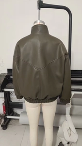Detail view of the olive green faux leather bomber jacket back with V-shaped stitching