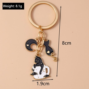 Detailed view of enamel black cat and moon keychain with 8cm length and 1.9cm width