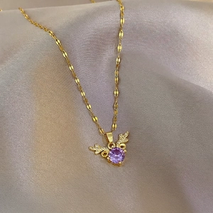 Elegant gold titanium necklace with purple zircon and diamond-encrusted wings on silk