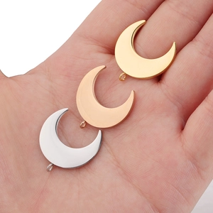 Mirror polished stainless steel moon pendants in gold rose gold and silver on palm