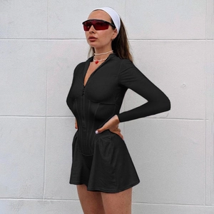 Close-up of black long sleeve bodycon romper featuring a front zipper and elastic fabric