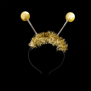 Detailed view of the gold tinsel alien headband with spring antenna for party costumes