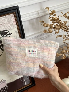 Rainbow striped plush makeup bag with soft macaron colors and brand woven label