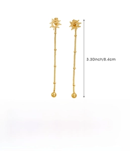 Detailed view of long gold sun earrings with size measurements and copper material specs