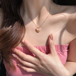 Pink tulip heart pendant necklace for women with gold chain shown on a model