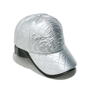 Close-up of silver quilted faux leather baseball cap with diamond pattern texture