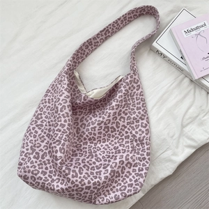 Top view of large purple leopard print tote bag with wide strap and creamy satin lining