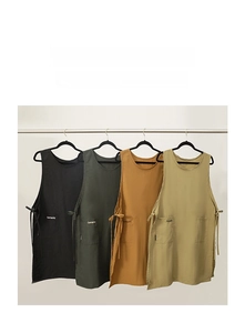 Detail of multi-color cotton linen aprons with dual front pockets and side ties