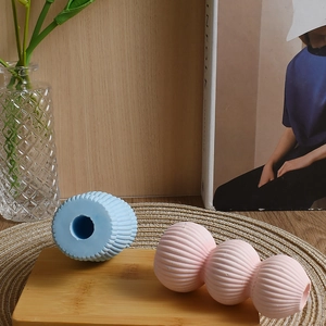 Vertical striped candle holder molds showing textured light blue and pink cylinder designs