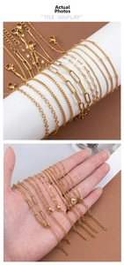 Detailed view of various 18K gold plated stainless steel chains showing diverse links