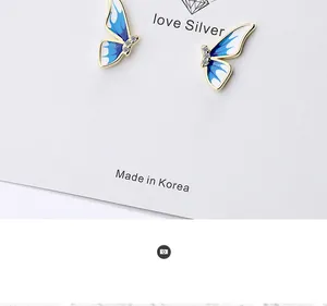 Detail of blue gradient enamel butterfly stud earrings with small zircon accents
