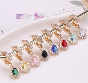 Detailed close-up of gold-plated sunflower earrings set with colorful gemstones