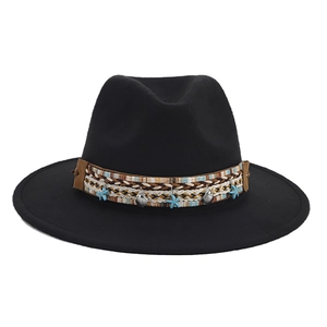 Detail of black fedora hat with woven band featuring starfish and seashell ornaments