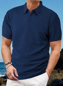 Detail of dark blue polo shirt featuring textured chevron knit fabric and three-button placket