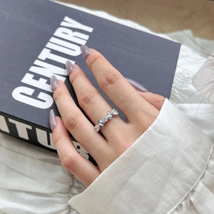 Detailed shot of an elegant S925 silver ring with blue heart zircon on a model hand