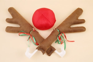 Close-up of brown plush reindeer antlers with festive red green bows and bells for cars