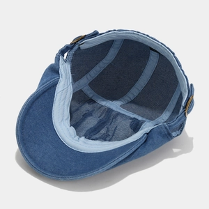 Internal view of a distressed denim flat cap showing the reinforced lining and sweatband