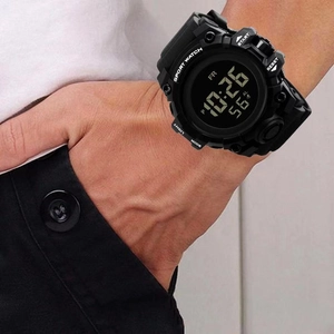 Close-up of a black multifunctional digital sports watch with a large display on a wrist