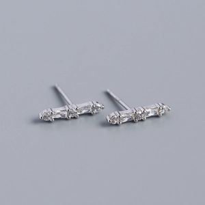 Macro detail of S925 silver bar earrings with round and baguette cut cubic zirconia stones
