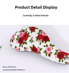 Detail of the detangling hairbrush featuring a romantic red and pink rose floral pattern
